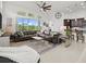 Inviting living area showcases bright natural light, a comfortable sectional sofa, and views of the outdoor scenery at 225 Mosaic Blvd, Daytona Beach, FL 32124