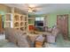 Cozy living room features neutral color scheme, tiled floors and ample seating at 2333 Fern Palm Dr, Edgewater, FL 32141