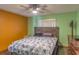 Comfortable bedroom with laminate flooring, ceiling fan, and wooden furniture at 2333 Fern Palm Dr, Edgewater, FL 32141