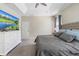 Bedroom with an upholstered bed, plush carpet, a television, and blue patterned curtains on the large windows at 2337 Oxmoor Dr, Deland, FL 32724