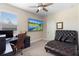 Bedroom features a chaise lounge, computer desk, ceiling fan and television on the wall at 2337 Oxmoor Dr, Deland, FL 32724