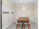Dining room featuring a wood table, chandelier, modern decor, and neutral color scheme at 2337 Oxmoor Dr, Deland, FL 32724