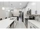 Well-lit kitchen featuring sleek countertops, stainless steel appliances, and a spacious island for cooking and dining at 2337 Oxmoor Dr, Deland, FL 32724