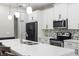 Bright kitchen equipped with stainless steel appliances, stylish countertops, and ample cabinet space for storage at 2337 Oxmoor Dr, Deland, FL 32724
