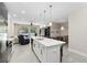 Open concept kitchen with a large island, stainless steel appliances, and views to the backyard and dining area at 2337 Oxmoor Dr, Deland, FL 32724