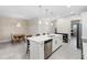 Bright kitchen featuring a large center island with pendant lighting, stainless steel appliances, and dining area at 2337 Oxmoor Dr, Deland, FL 32724