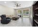 Spacious living room with large windows, modern ceiling fan, comfortable seating, and access to the backyard at 2337 Oxmoor Dr, Deland, FL 32724