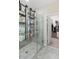 Shower with modern fixtures, glass doors, integrated shelving, and direct access to a walk-in closet at 2337 Oxmoor Dr, Deland, FL 32724