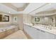 Luxurious bathroom featuring a double vanity, soaking tub, and modern finishes at 241 Riverside Dr # 902, Holly Hill, FL 32117
