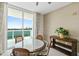 Dining area with water view, a glass table, and neutral tones, creating an inviting space for meals at 241 Riverside Dr # 902, Holly Hill, FL 32117