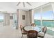 Bright dining area with a glass-top table and seating, offering stunning water views through large windows at 241 Riverside Dr # 902, Holly Hill, FL 32117
