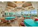 Bright event space with turquoise tablecloths, modern chandeliers, and floor-to-ceiling windows boasting water views at 241 Riverside Dr # 902, Holly Hill, FL 32117