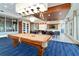Bright and spacious game room featuring a billiards table, tables and chairs and TV at 241 Riverside Dr # 902, Holly Hill, FL 32117