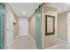 Inviting hallway with tile flooring, a custom sliding door, and neutral wall color create a stylish entry at 241 Riverside Dr # 902, Holly Hill, FL 32117