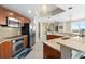 Modern kitchen boasts stainless steel appliances, wood cabinets, a backsplash, and an open layout at 241 Riverside Dr # 902, Holly Hill, FL 32117