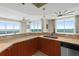 Kitchen with views, featuring granite countertops, stainless steel appliances, and a breakfast bar at 241 Riverside Dr # 902, Holly Hill, FL 32117