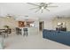 Open-concept living space with breakfast bar, tile floors, stainless appliances, & a cozy blue sofa at 241 Riverside Dr # 902, Holly Hill, FL 32117
