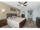 A main bedroom featuring hardwood floors, a decorative wall, and neutral-toned bedding at 241 Riverside Dr # 902, Holly Hill, FL 32117