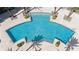 Aerial view of a uniquely shaped community pool surrounded by palm trees and lush landscaping in the pool area at 241 Riverside Dr # 902, Holly Hill, FL 32117