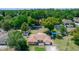 Aerial view of a single-Gathering home, with a large backyard and mature trees surrounding the property at 242 Linda Vista St, Debary, FL 32713