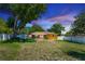 Spacious backyard with lawn, screened-in lanai, large trees, and full privacy fence at 242 Linda Vista St, Debary, FL 32713