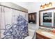 Nautical-themed bathroom featuring patterned shower curtain, wooden vanity and cabinet, and decorative mirror at 242 Linda Vista St, Debary, FL 32713