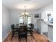 Light-filled dining room with wood floors adjacent to the renovated kitchen at 242 Linda Vista St, Debary, FL 32713