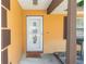 Close up of front door featuring a detailed oval window and a 'Hello' welcome mat at 242 Linda Vista St, Debary, FL 32713