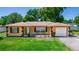 Charming single-story home featuring well-manicured lawn and neat, appealing landscaping at 242 Linda Vista St, Debary, FL 32713