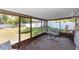 Relaxing screened-in lanai with hammock, view of spacious backyard and privacy fence at 242 Linda Vista St, Debary, FL 32713