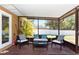 Screened lanai with outdoor seating, table, privacy screen, and view of the backyard at 242 Linda Vista St, Debary, FL 32713