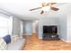 Living room with hardwood floors, ceiling fan, and view into adjacent rooms at 242 Linda Vista St, Debary, FL 32713
