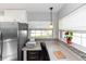 Bright office space with modern decor, stainless appliances, and natural light from the window at 242 Linda Vista St, Debary, FL 32713