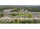 Drone view of the neighborhood and home with many solar panels and lush surroundings at 2518 Hoptree Ln, Edgewater, FL 32141