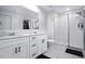 Modern bathroom with double sink vanity, white cabinetry, and a glass-enclosed shower at 2518 Hoptree Ln, Edgewater, FL 32141