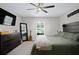 Comfortable bedroom showcasing a large bed with a wooden headboard, dresser, and natural light at 2518 Hoptree Ln, Edgewater, FL 32141