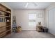 Bright, organized bedroom with bookshelves and window; a perfect home office or room at 2518 Hoptree Ln, Edgewater, FL 32141