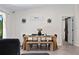 Dining room featuring a wooden table, black seating, and a decorative wall art, and a sliding barn door at 2518 Hoptree Ln, Edgewater, FL 32141