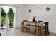 Dining room with modern wood furniture and open glass sliding doors providing an abundance of natural light at 2518 Hoptree Ln, Edgewater, FL 32141