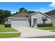 Charming single Gathering home with a two-car garage and well-manicured front lawn at 2518 Hoptree Ln, Edgewater, FL 32141