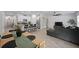 Open-concept living room and kitchen featuring modern furniture, stainless steel appliances and an island at 2518 Hoptree Ln, Edgewater, FL 32141