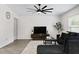 Bright living room featuring a large sectional sofa, modern ceiling fan, and sleek entertainment center at 2518 Hoptree Ln, Edgewater, FL 32141