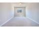 Spacious bedroom with neutral walls and carpet and large window view at 258 Rustic Loop, Sanford, FL 32771