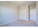 Well-lit bedroom with carpet, closet and white door at 258 Rustic Loop, Sanford, FL 32771