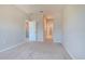 Spacious bedroom with neutral walls and carpet, offering seamless access to adjacent rooms at 258 Rustic Loop, Sanford, FL 32771