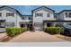 Townhome with brick driveway, attached garage, manicured shrubs, and neutral paint at 258 Rustic Loop, Sanford, FL 32771