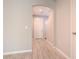 Inviting hallway with wood-look tile floors provides a seamless transition between rooms at 258 Rustic Loop, Sanford, FL 32771