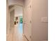 Bright hallway with wood-look tile floors, leading to an open living space and outdoor patio at 258 Rustic Loop, Sanford, FL 32771