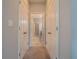 Hallway with carpet and white doors leads to other rooms in the house, providing privacy at 258 Rustic Loop, Sanford, FL 32771