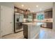 Bright kitchen with stainless appliances, dark cabinets, and a spacious center island at 258 Rustic Loop, Sanford, FL 32771